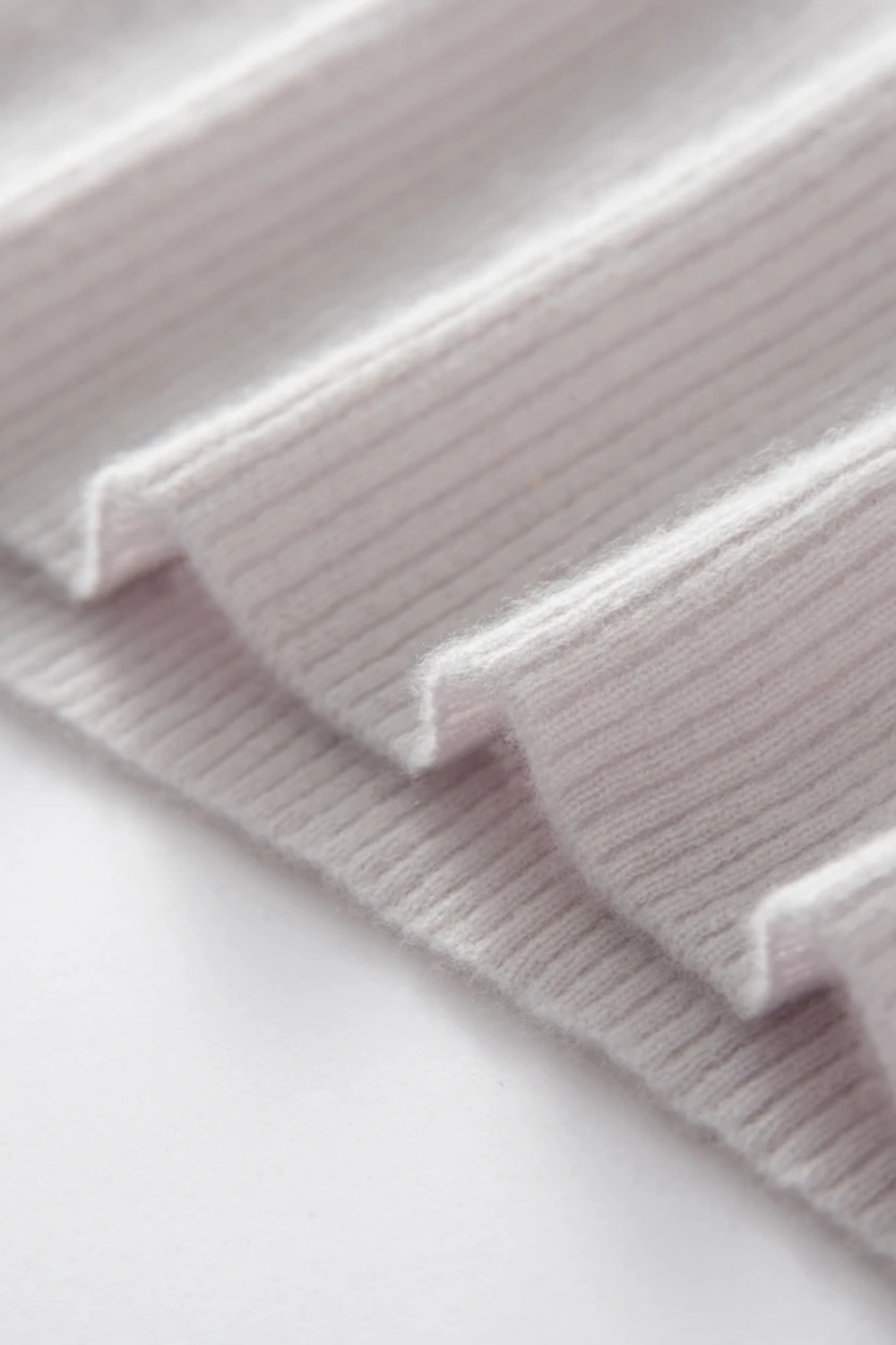 Close-up of a cream knit fabric texture