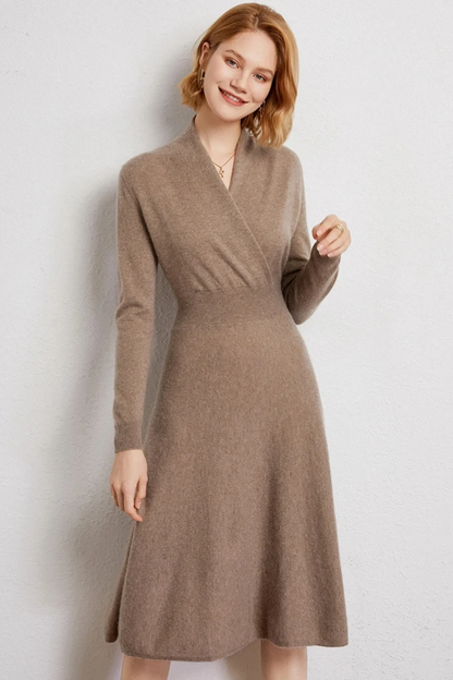Woman wearing a beige coloured wrap dress against a white background