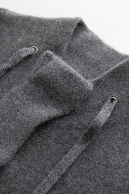 Close-up of a gray cardigan with drawstrings on a light gray background