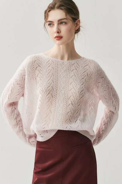 Woman wearing a light pink knitted sweater against a white background