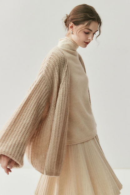 Woman wearing a camel knit cardigan and skirt on a white background