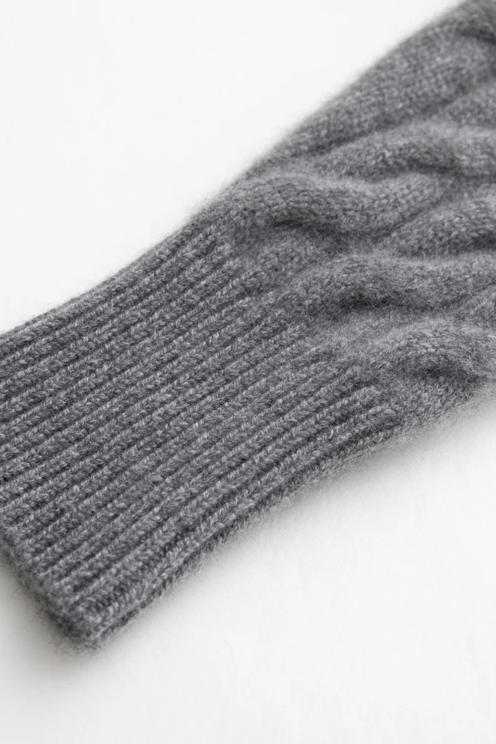 Gray knitted glove on a white background