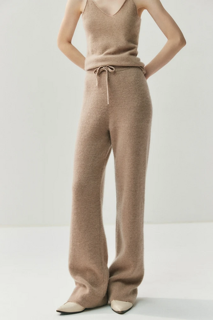 Woman wearing a camel-coloured knit outfit on a white background