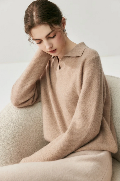 Woman wearing a camel coloured sweater against a plain background