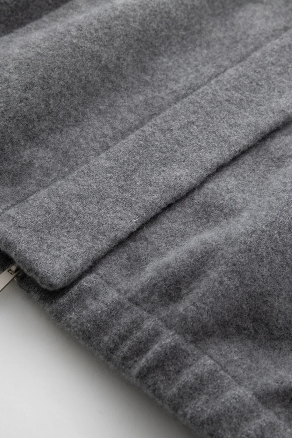 Close-up of a gray fabric texture with a zipper