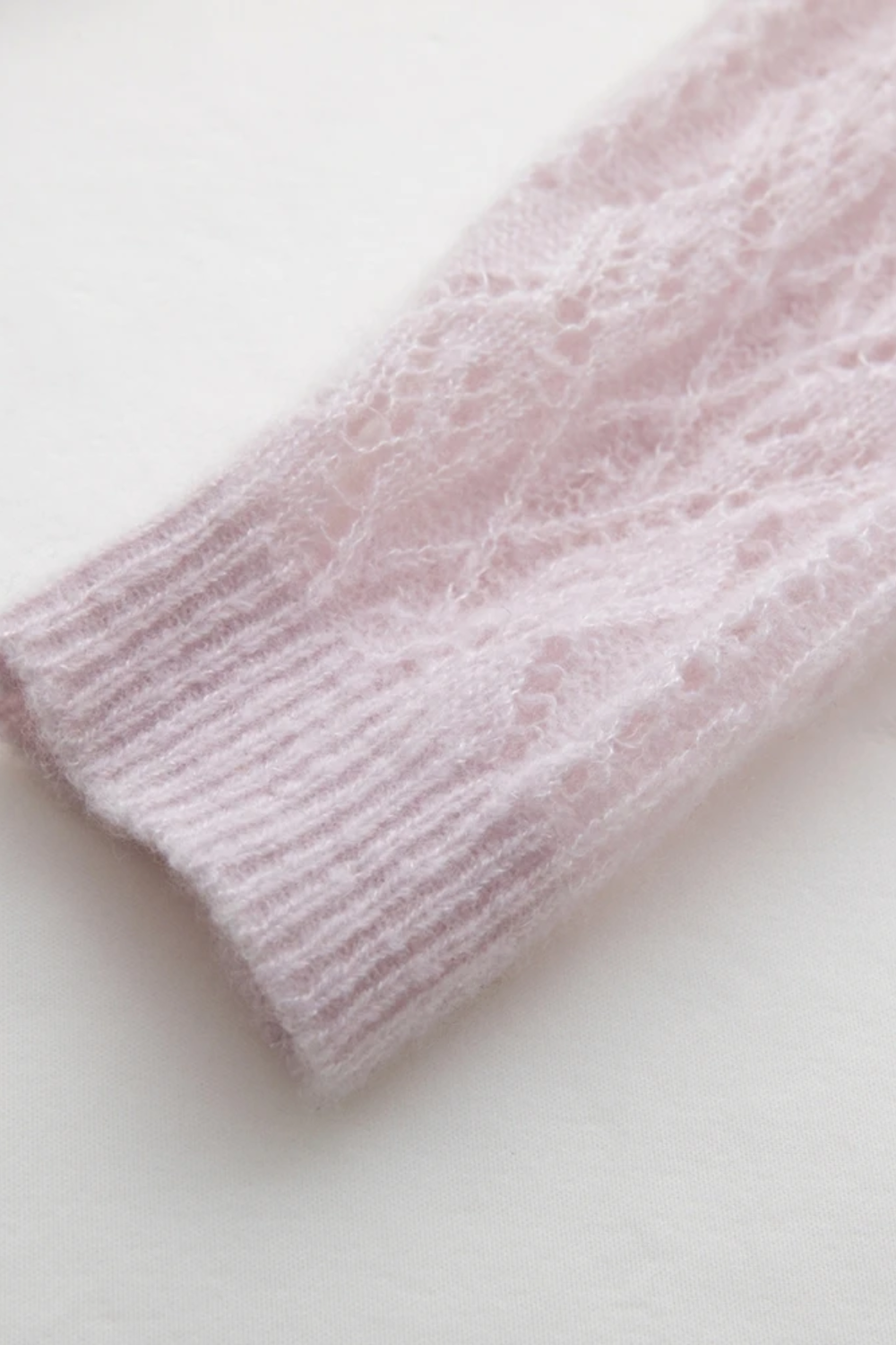 Close-up of a pink knitted fabric on a white background