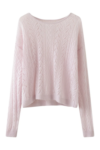 Pink cable knit sweater on a white background