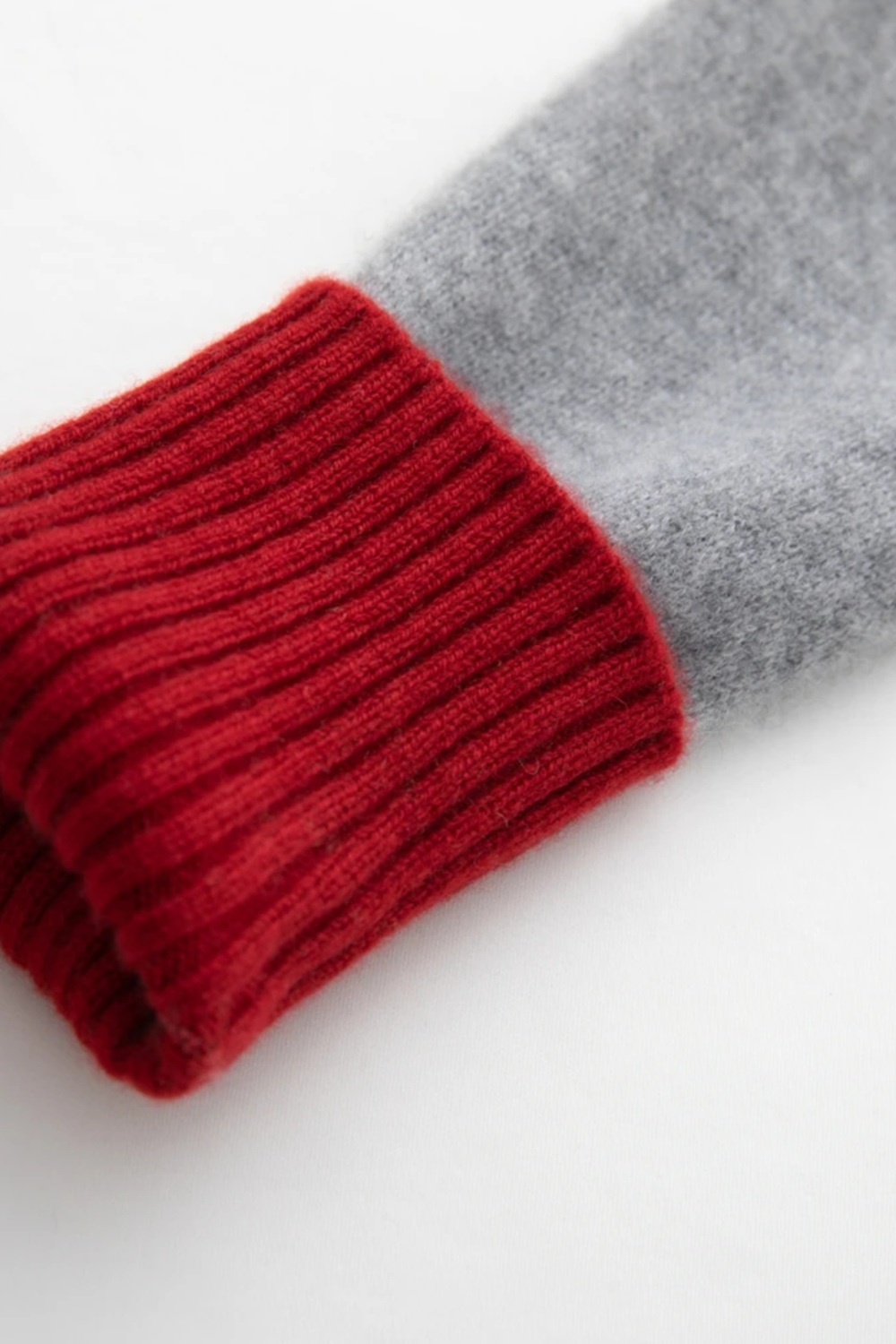 Close-up of red and gray knitted socks on a white background