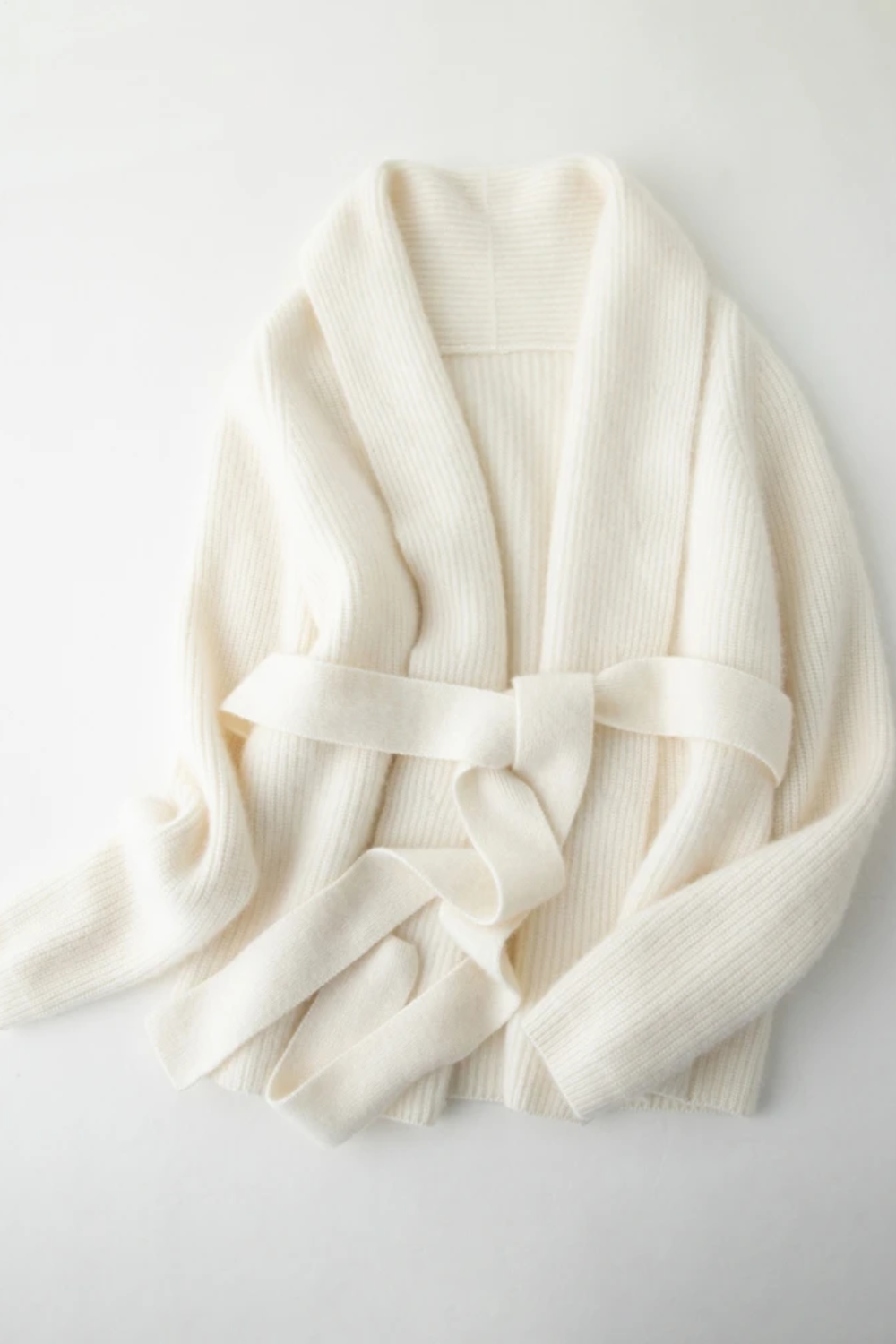 White robe cardigan with a belt on a light gray background