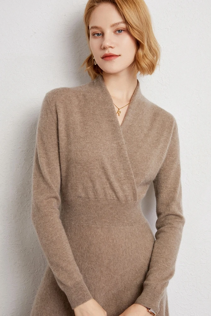 Woman wearing a beige dress against a light background