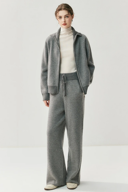 Person wearing a gray outfit with a white background